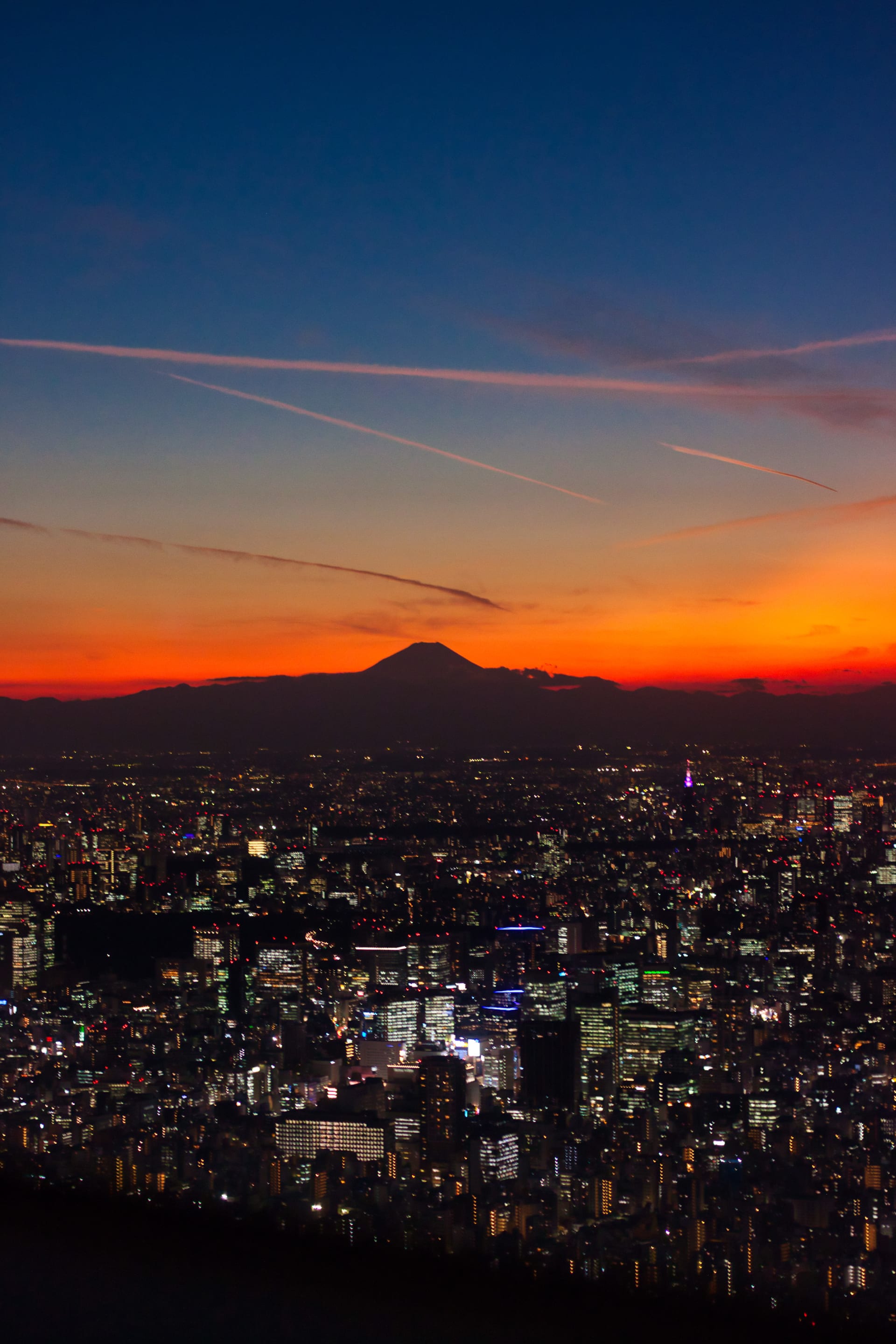 Silhouette of Mount Fuji rising from the Tokyo skyline as the sun sets over the horizon. A perfect backdrop to end the trip with. Unfortunately, I couldn't see Mount Fuji up close during my trip to Kawaguchi-ko because of the rain, but this view makes up for it.
